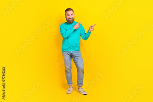 Full body photo of attractive grandpa fingers point empty promo poster space dressed stylish cyan look isolated on yellow color background