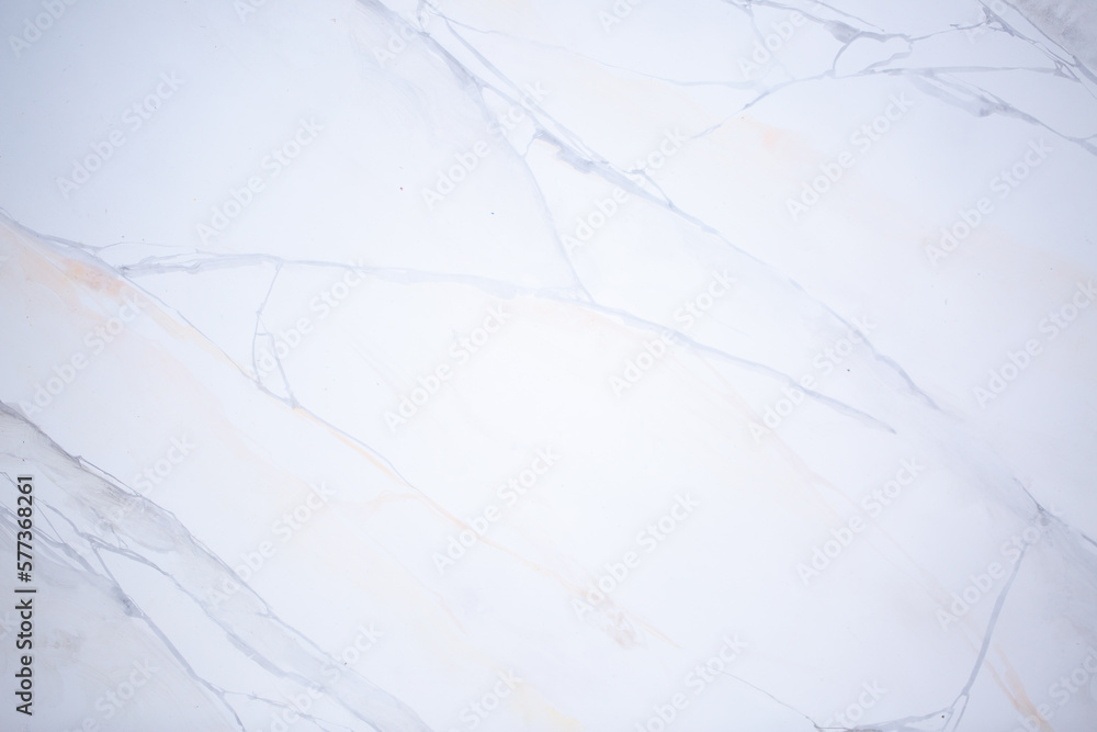 Light background of decorative plaster with abstract spots. Unusual texture of white or gray wall with beautiful patterns, creative surface background. Finishing coating for building cladding.