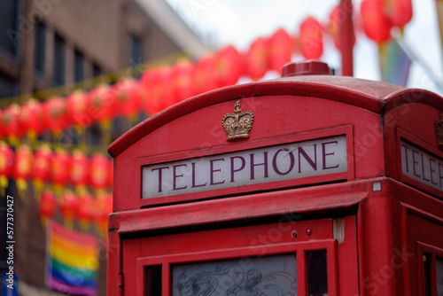 Canvas Print Red call box in London Chinatown (Soho), with LGBT flag in the background