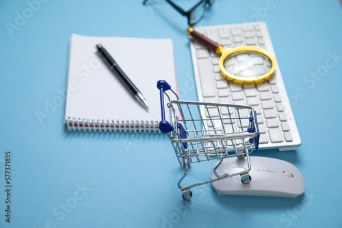 Shopping cart with a computer keyboard and business objects.