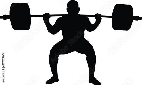 athlete powerlifter with barbell on shoulders in squatting