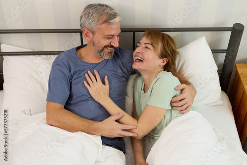 Mature couple relaxing in bed in the morning at home © Stockphotodirectors