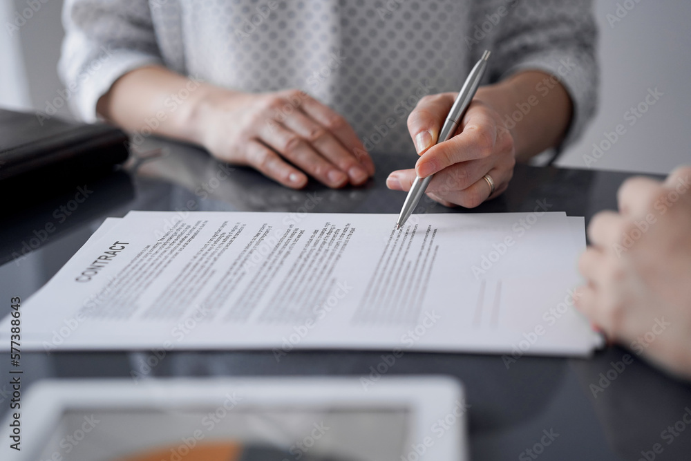 Business people signing contract papers while sitting at the glass table in office, closeup. Partners or lawyers working together at meeting. Teamwork, partnership, success concept. Business people signing contract papers while sitting at the glass table in office, closeup. Partners or lawyers working together at meeting. Teamwork, partnership, success concept.