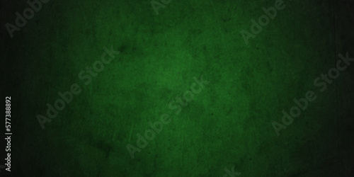 Dark green background with grunge backdrop texture, watercolor painted mottled green background, colorful bright ink and watercolor textures on black grunge wall paper background.