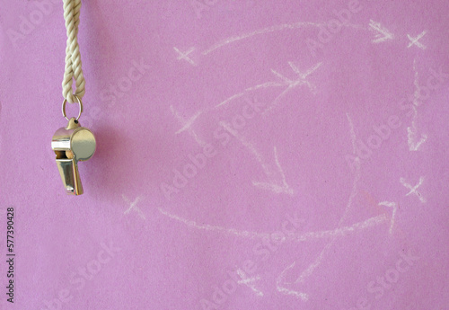 Whistle of soccer referee or trainer and soccer tactics scribble on pink background. Women's soccer concept