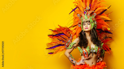 Fototapeta Naklejka Na Ścianę i Meble -  Beautiful brazilian woman in brazilian carnival costume on yellow background