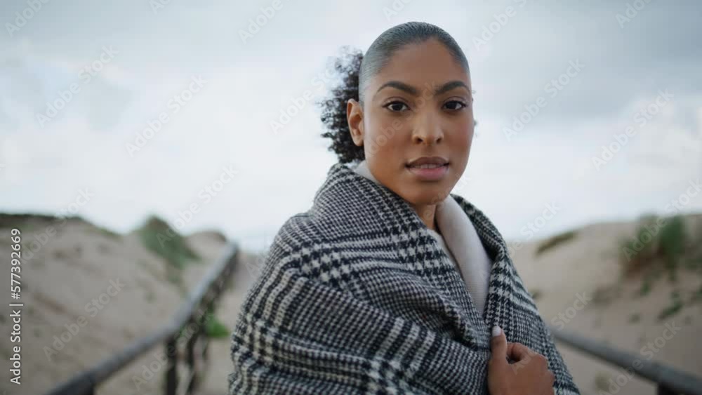 African american walking sand dunes closeup. Serene woman turning looking camera African american walking sand dunes closeup. Serene woman turning looking camera