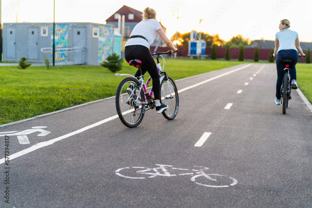 people in a blur on a bike path