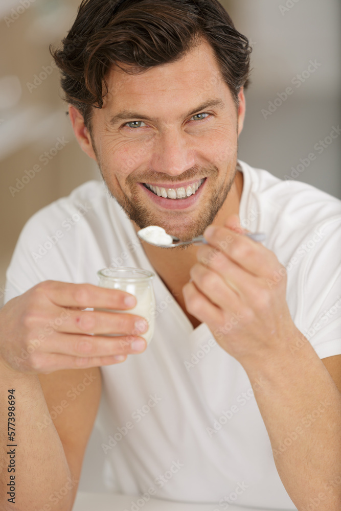 healthy eating man yogurt in the kitchen healthy eating man yogurt in the kitchen