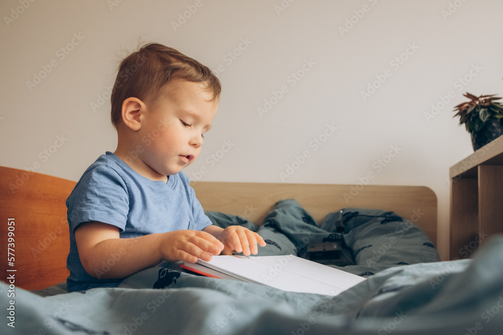 child reading a book to her daughter before nap child reading a book to her daughter before nap