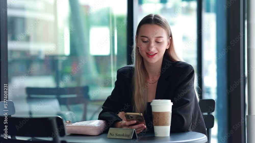 Smilling Beautiful Caucasian woman using smartphone for social media during rest in modern cafe shop Smilling Beautiful Caucasian woman using smartphone for social media during rest in modern cafe shop