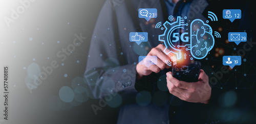 Close up of male hand holding a phone with a 5G hologram. 5G network wireless systems.The concept of 5G network, high-speed mobile Internet, new generation networks.
