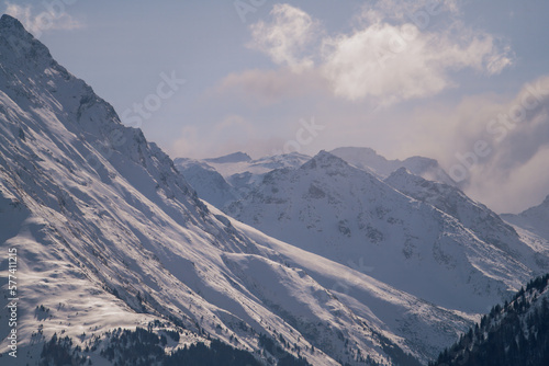 beautiful view to the snow capped alps, the hohe tauern in austria, at a sunny winter day with foehn clouds