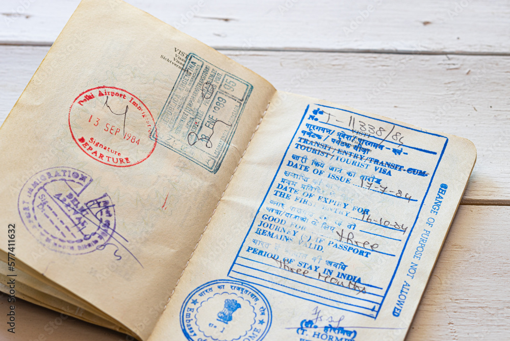 Naklejka premium Old Indian Visa with arrival and departure dates on a passport. Holidays concept.