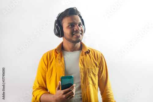 happy young man enjoying music with headphone and mobile phone © paltu