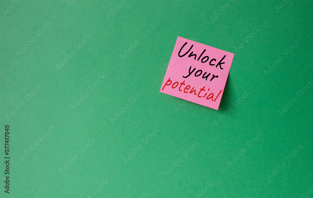 Unlock your Potential symbol. Concept words Unlock your Potential on pink steaky note. Beautiful green background. Business and Unlock your Potential concept. Copy space. Unlock your Potential symbol. Concept words Unlock your Potential on pink steaky note. Beautiful green background. Business and Unlock your Potential concept. Copy space.