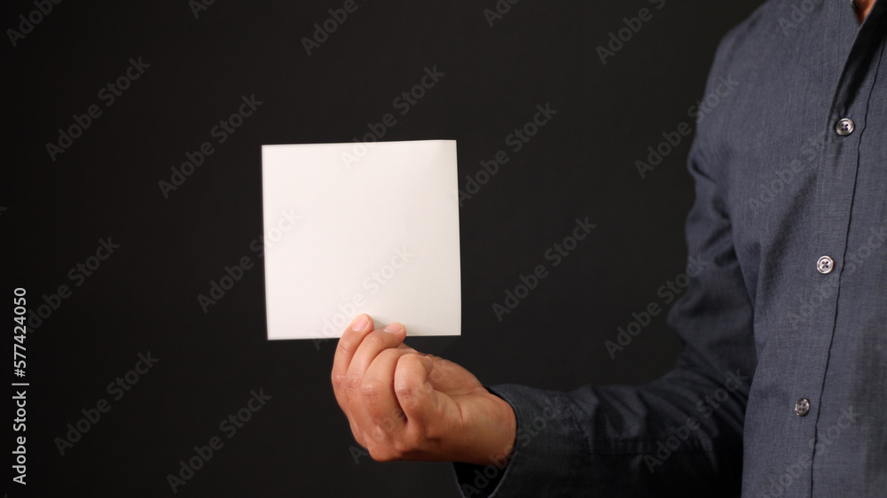 Man holding white blank square paper. Businessman show empty card Man holding white blank square paper. Businessman show empty card