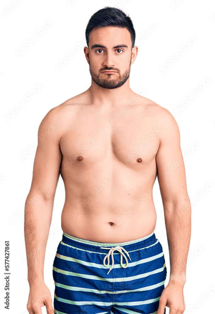 Fototapeta premium Young handsome man wearing swimwear depressed and worry for distress, crying angry and afraid. sad expression.