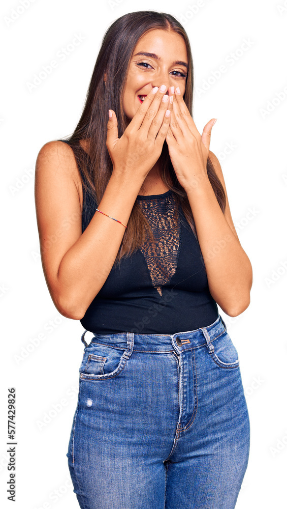 Young hispanic woman wearing casual clothes laughing and embarrassed giggle covering mouth with hands, gossip and scandal concept Young hispanic woman wearing casual clothes laughing and embarrassed giggle covering mouth with hands, gossip and scandal concept
