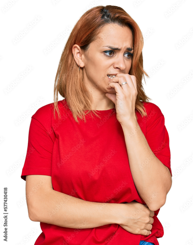 Hispanic young woman wearing casual red t shirt looking stressed and nervous with hands on mouth biting nails. anxiety problem. Hispanic young woman wearing casual red t shirt looking stressed and nervous with hands on mouth biting nails. anxiety problem.