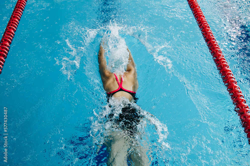Successful female swimmer swimming in the pool. A professional athlete