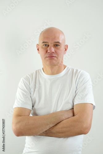 man bald in white T-shirt question in eyes folded hands recruitment social service support for refugees human rights issues job search washing powder skin care cleaning tools in toilet men hygiene