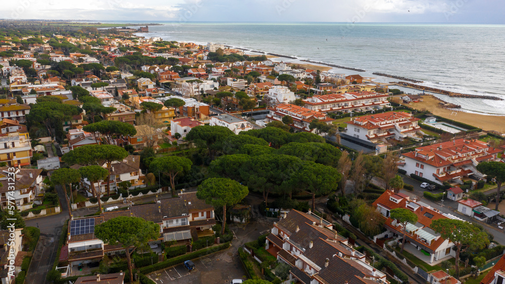 Aerial view of Santa Severa, a fraction of Santa Marinella, in the Metropolitan City of Rome, Italy. It is a small seaside town built along the coast. There are many small villas.