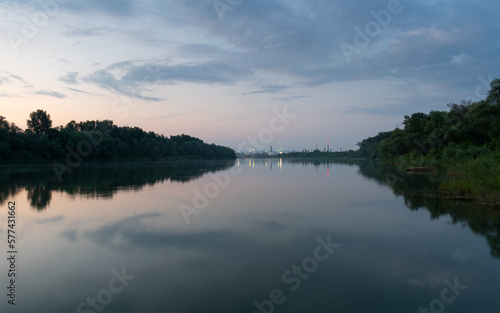 Landscape of Sava river and oil refinery at dusk, petrochemical industry