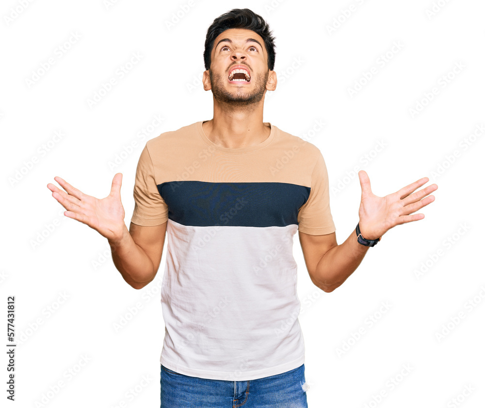 Young handsome man wearing casual clothes crazy and mad shouting and yelling with aggressive expression and arms raised. frustration concept. Young handsome man wearing casual clothes crazy and mad shouting and yelling with aggressive expression and arms raised. frustration concept.