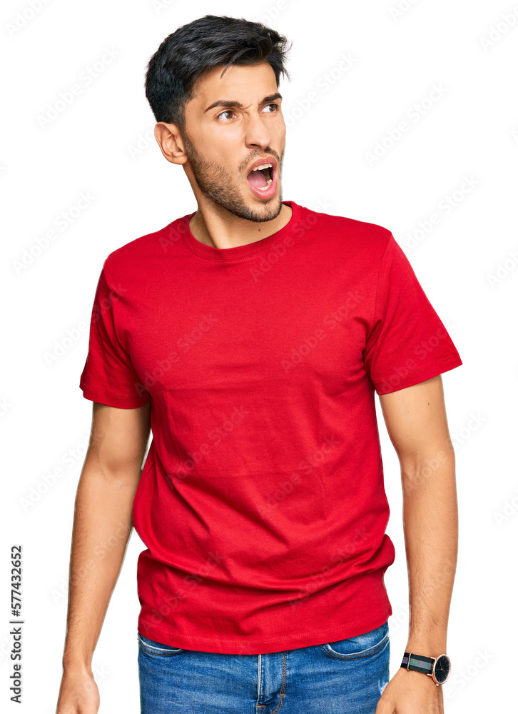 Young handsome man wearing casual red tshirt angry and mad screaming frustrated and furious, shouting with anger. rage and aggressive concept. Young handsome man wearing casual red tshirt angry and mad screaming frustrated and furious, shouting with anger. rage and aggressive concept.