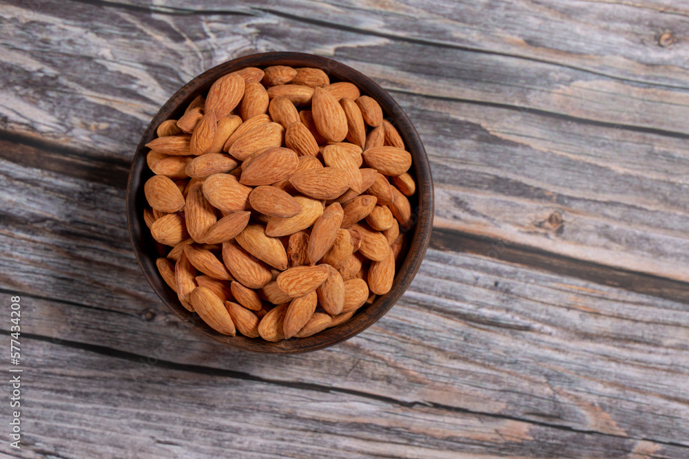 almonds in a wooden bowl almonds in a wooden bowl