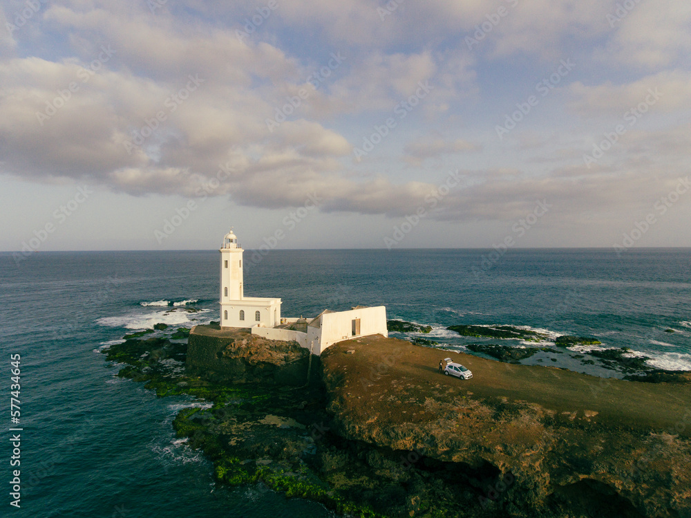 Aerial photos of Farol da Praia in Santiago, Cape Verde showcase a stunning lighthouse on a rugged coastline with breathtaking views of the Atlantic Ocean, surrounded by dramatic cliffs, sandy beaches