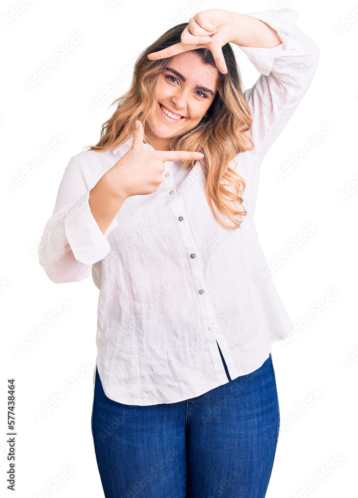 Fototapeta premium Young caucasian woman wearing casual clothes smiling making frame with hands and fingers with happy face. creativity and photography concept.