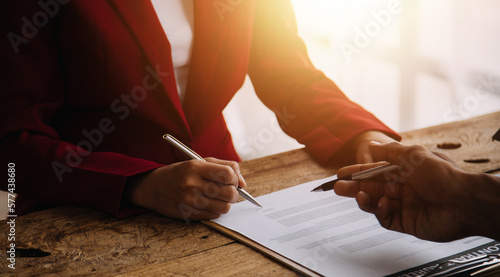 Real estate broker agent presenting and consult to customer to decision making sign insurance form agreement, buy and sell home model, concerning mortgage loan offer for and house insurance