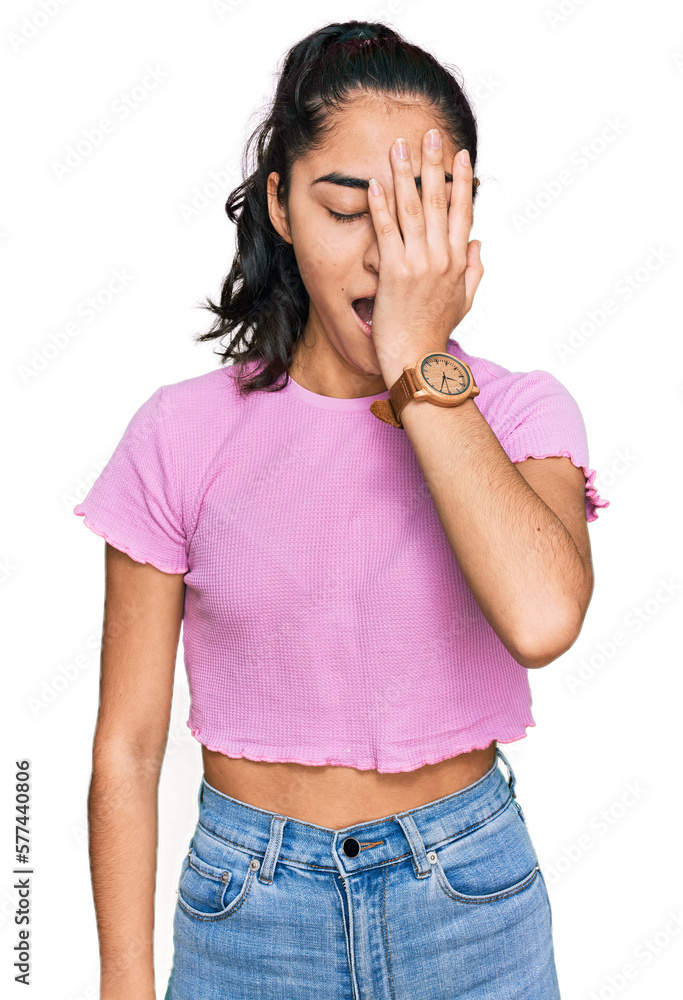 Hispanic teenager girl with dental braces wearing casual clothes yawning tired covering half face, eye and mouth with hand. face hurts in pain. Hispanic teenager girl with dental braces wearing casual clothes yawning tired covering half face, eye and mouth with hand. face hurts in pain.
