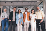 Group of diverse colleagues standing in contemporary workspace