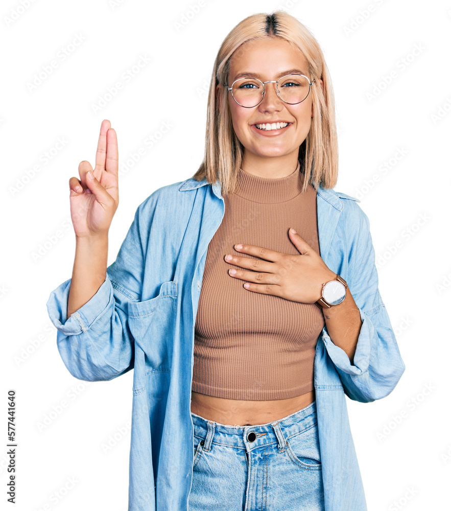 Beautiful young blonde woman wearing glasses smiling swearing with hand on chest and fingers up, making a loyalty promise oath Beautiful young blonde woman wearing glasses smiling swearing with hand on chest and fingers up, making a loyalty promise oath