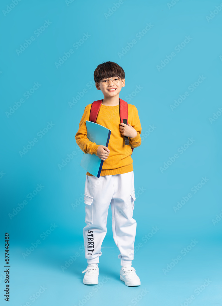 © Q88 - Portrait of Asian school boy born on a blue background © Q88 - Portrait of Asian school boy born on a blue background