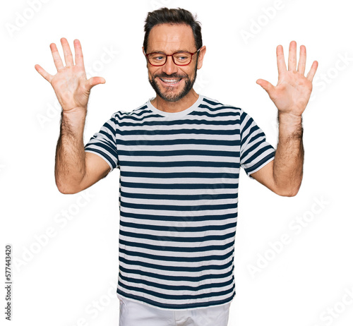 Middle age man wearing casual clothes and glasses showing and pointing up with fingers number ten while smiling confident and happy.