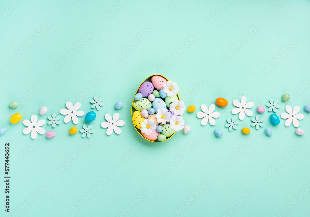 Easter Eggs with Sweets and Spring Flowers on Blue Background
