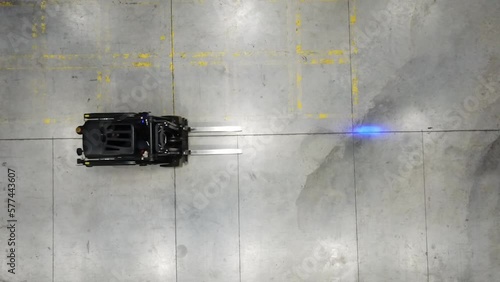 4K Aerial forklift enters the frame. Bird’s eye warehouse top down powered industrial truck stock video.
