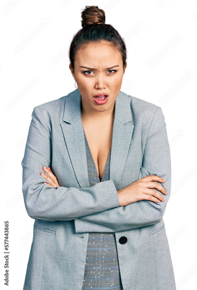 Young hispanic girl wearing business clothes in shock face, looking skeptical and sarcastic, surprised with open mouth Young hispanic girl wearing business clothes in shock face, looking skeptical and sarcastic, surprised with open mouth