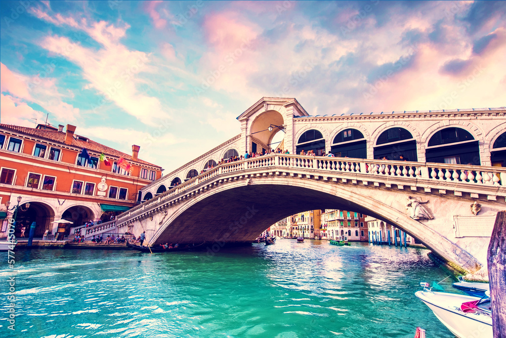 Bright charming landscape with  Rialto Bridge at sunset in Venice, Italy. Amazing places. Popular tourist atraction.