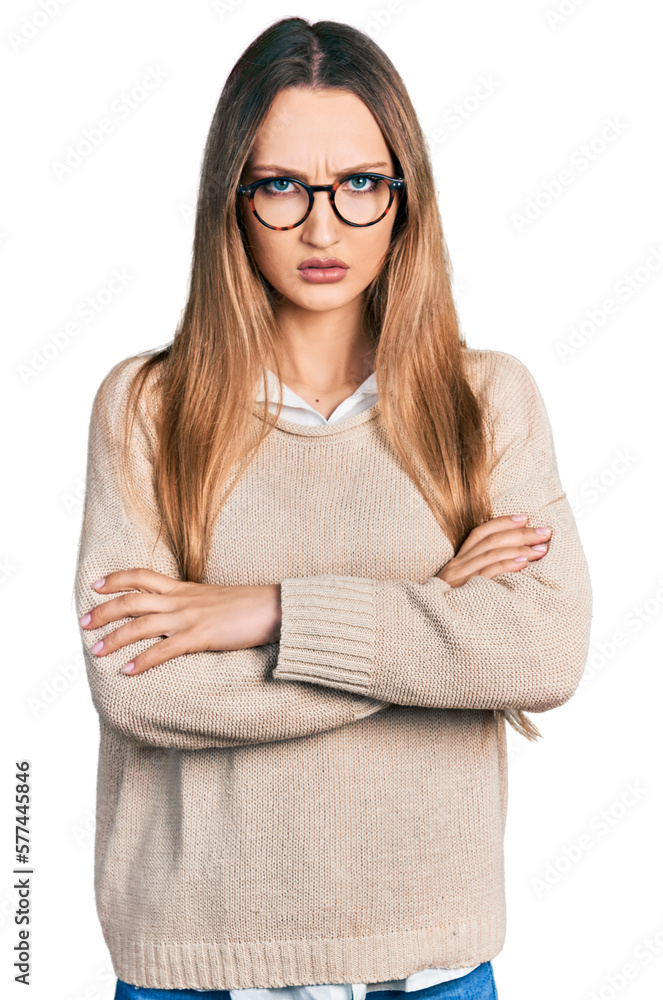 Beautiful caucasian woman wearing casual sweater and glasses skeptic and nervous, disapproving expression on face with crossed arms. negative person.