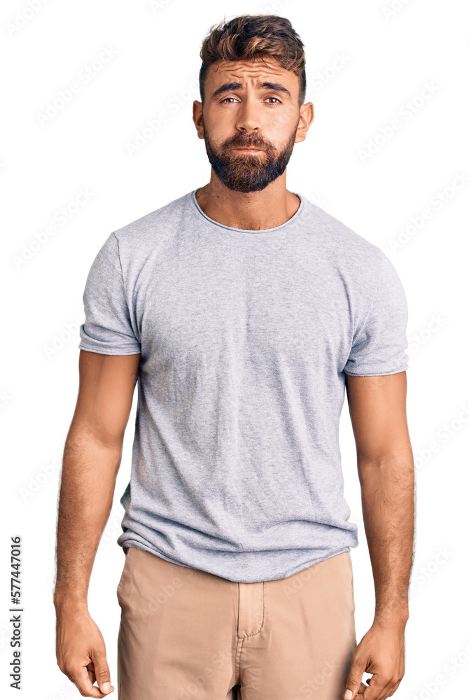 Young hispanic man wearing casual clothes puffing cheeks with funny face. mouth inflated with air, crazy expression. Young hispanic man wearing casual clothes puffing cheeks with funny face. mouth inflated with air, crazy expression.