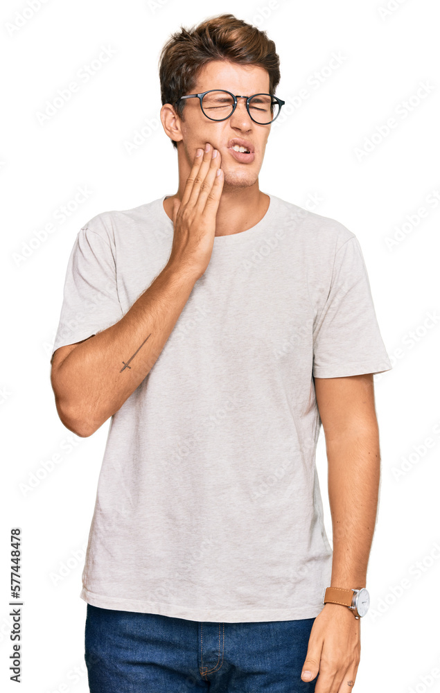 Handsome caucasian man wearing casual clothes and glasses touching mouth with hand with painful expression because of toothache or dental illness on teeth. dentist Handsome caucasian man wearing casual clothes and glasses touching mouth with hand with painful expression because of toothache or dental illness on teeth. dentist