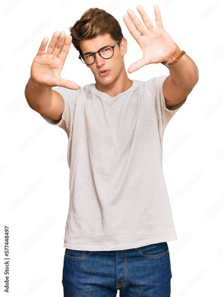 Handsome caucasian man wearing casual clothes and glasses doing frame using hands palms and fingers, camera perspective Handsome caucasian man wearing casual clothes and glasses doing frame using hands palms and fingers, camera perspective