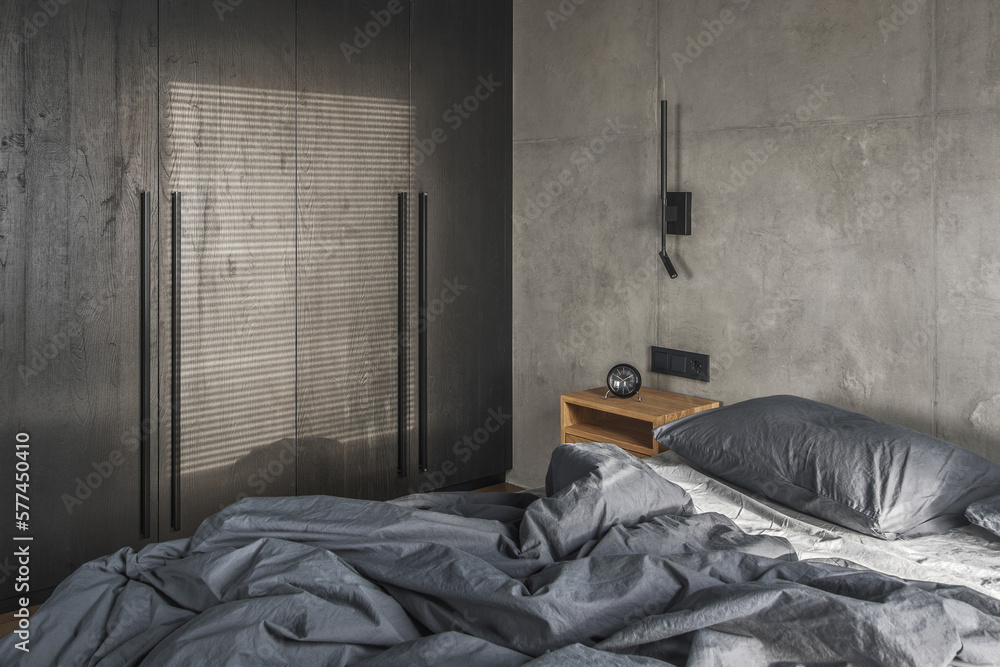 Minimalistic black wall light in modern bedroom interior in grey and ...