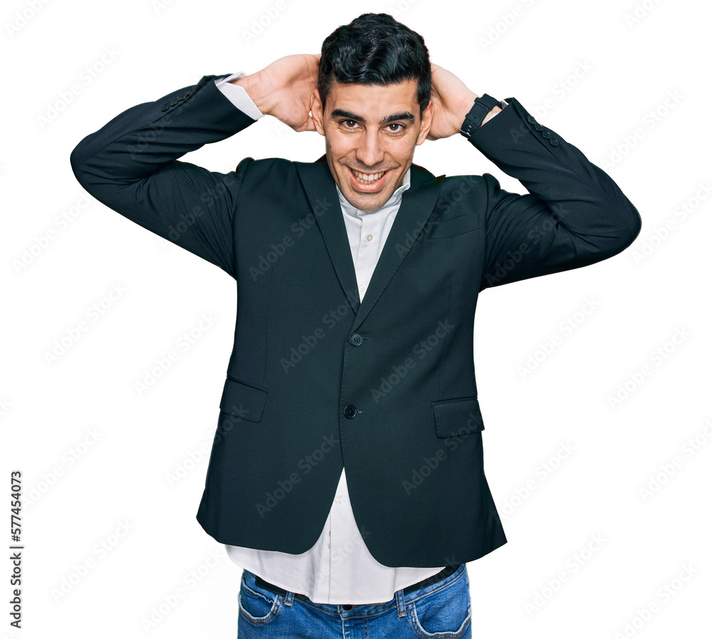 Handsome hispanic man wearing business clothes relaxing and stretching, arms and hands behind head and neck smiling happy Handsome hispanic man wearing business clothes relaxing and stretching, arms and hands behind head and neck smiling happy