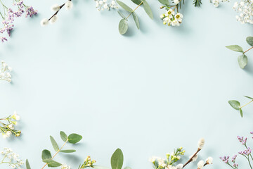 Spring flower frame on blue background copy space flat lay mock up